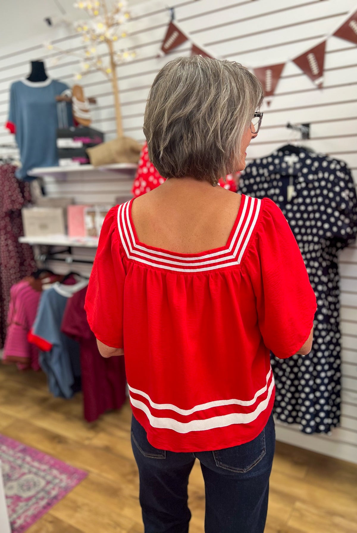 Red short sleeve top with white contrast stripe trim at neckline and hem