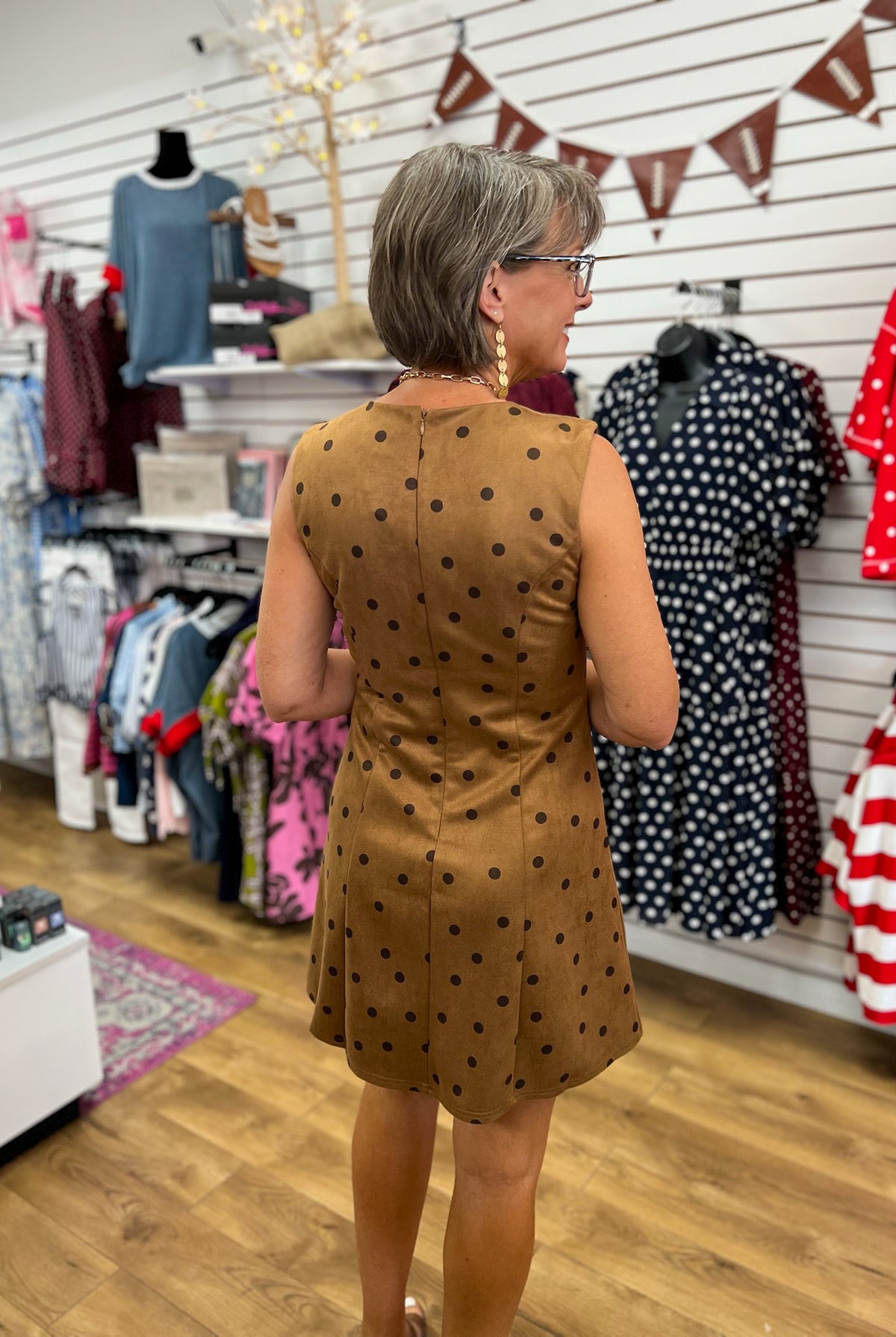 Brown sleeveless suede mini dress with dark polka dots and back zipper