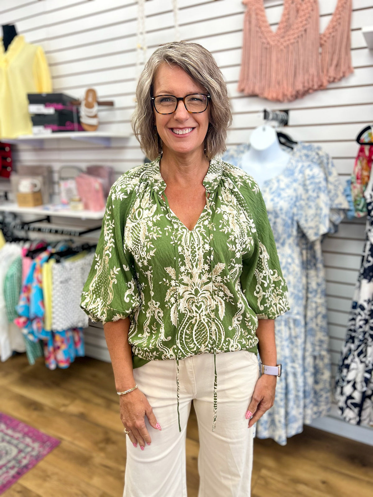 Olive green boho border print top with 3/4 balloon sleeves and tie neckline