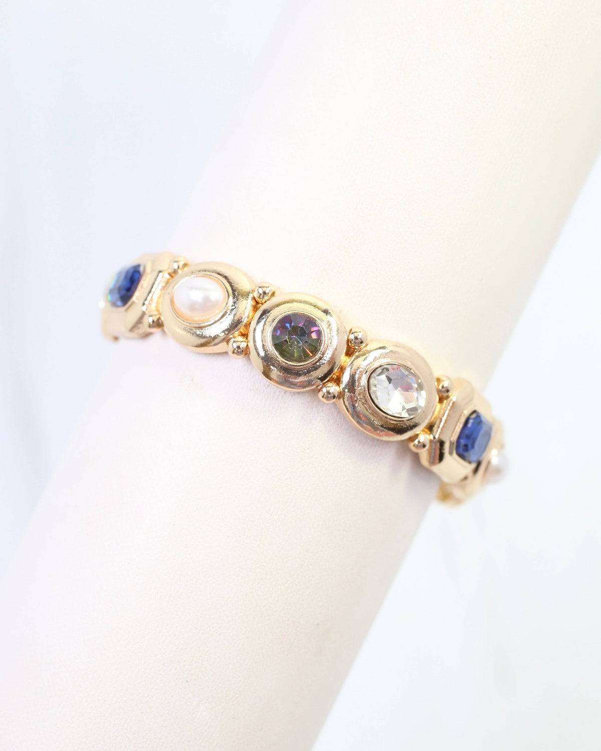 Gold stretch bracelet with blue, green, clear crystal and pearl bezel-set stones