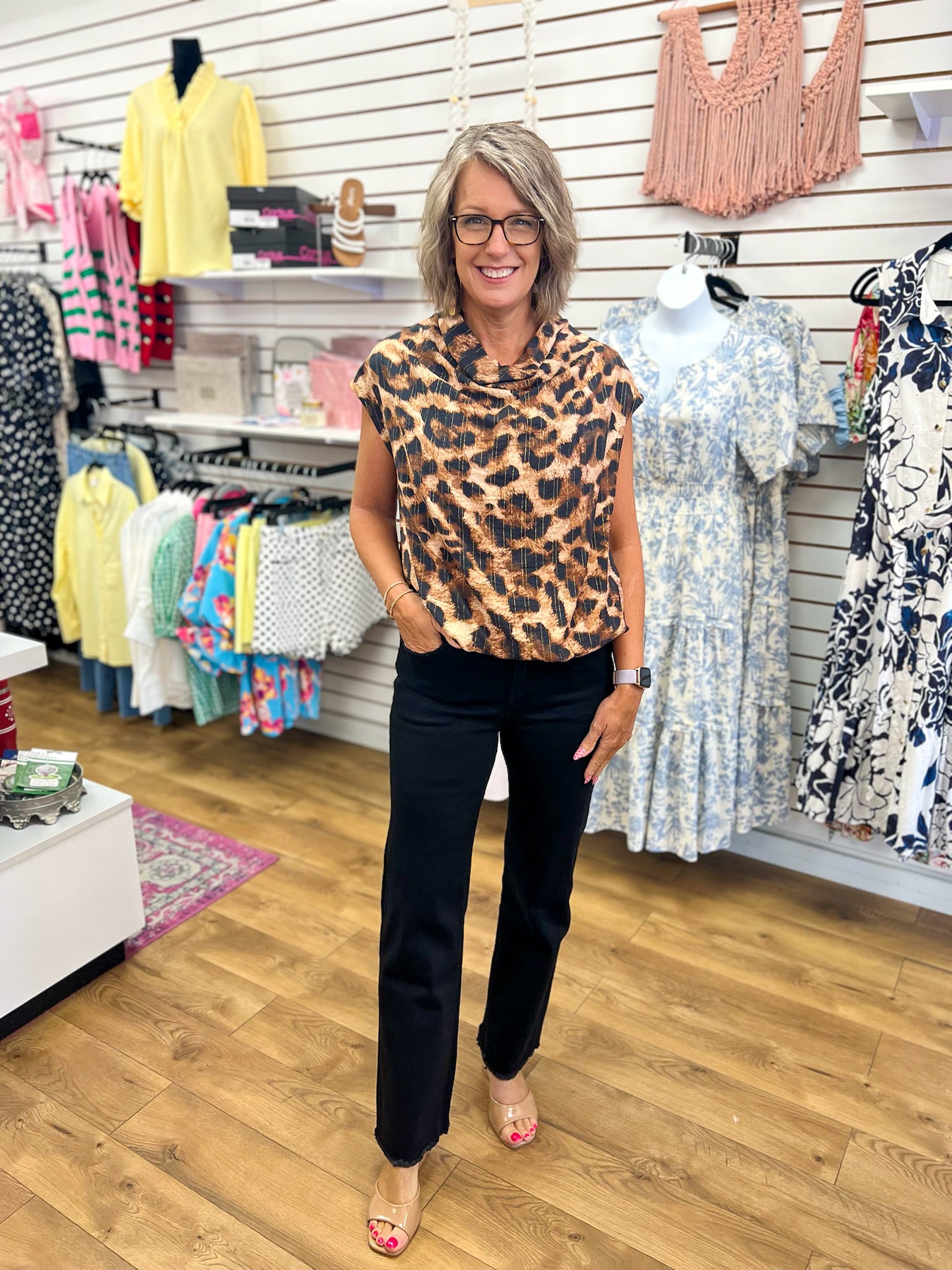 Umgee brown leopard print sleeveless mock neck top styled with black wide-leg pants