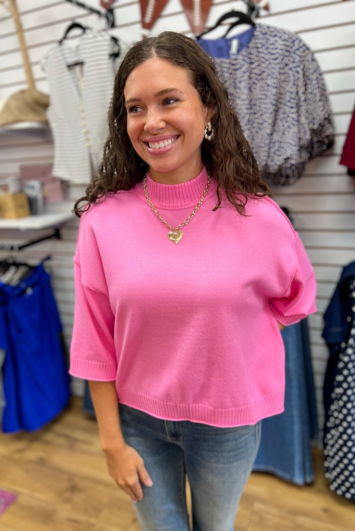 Glam pink mock neck cropped sweater with 3/4 sleeves worn with jeans