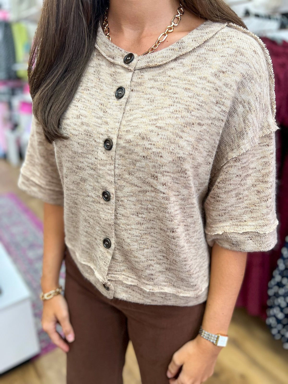 Light taupe marled knit button-down short sleeve top with raw hem details