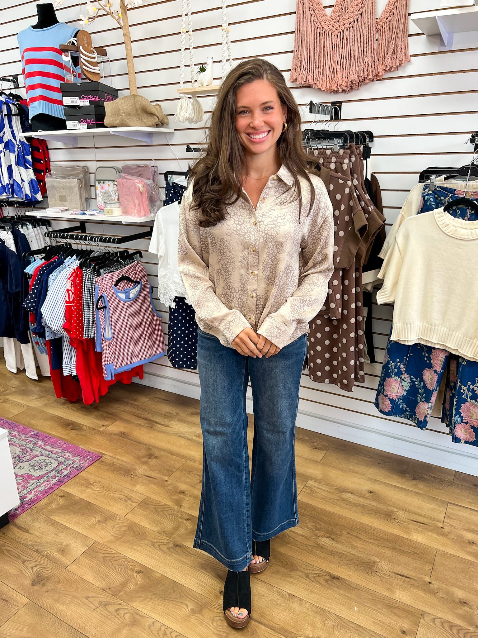 Taupe leopard print long sleeve button-up top styled with wide-leg jeans
