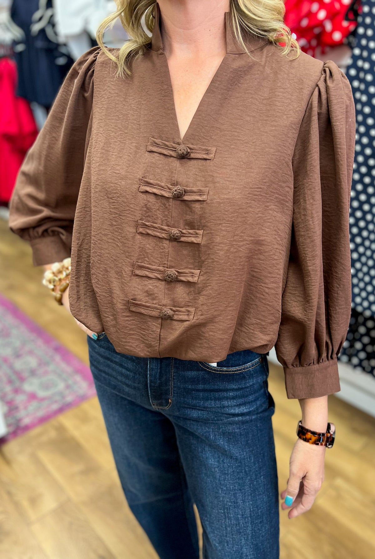 Brown v-neck puff sleeve blouse with frog closures and bubble hem by Entro