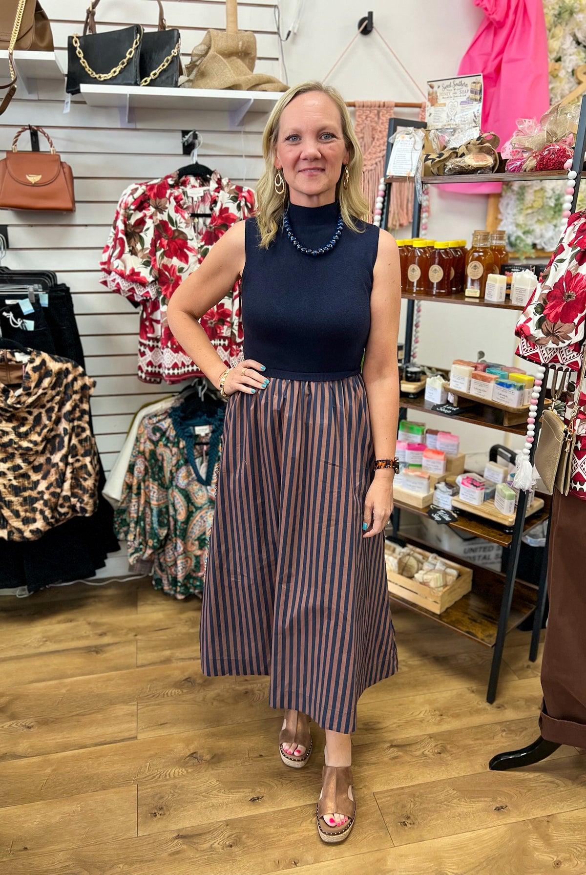 Navy sleeveless mock neck midi dress with brown striped A-line skirt