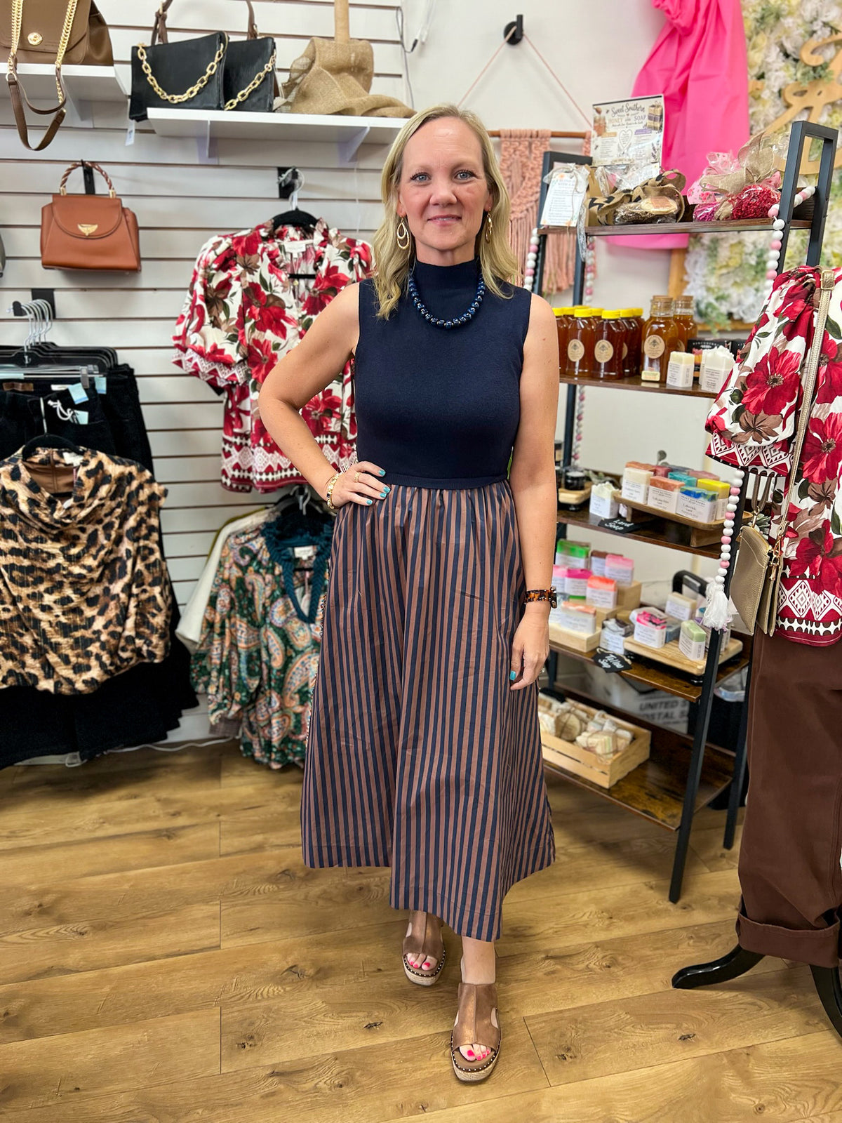 Navy sleeveless mock neck midi dress with brown striped A-line skirt