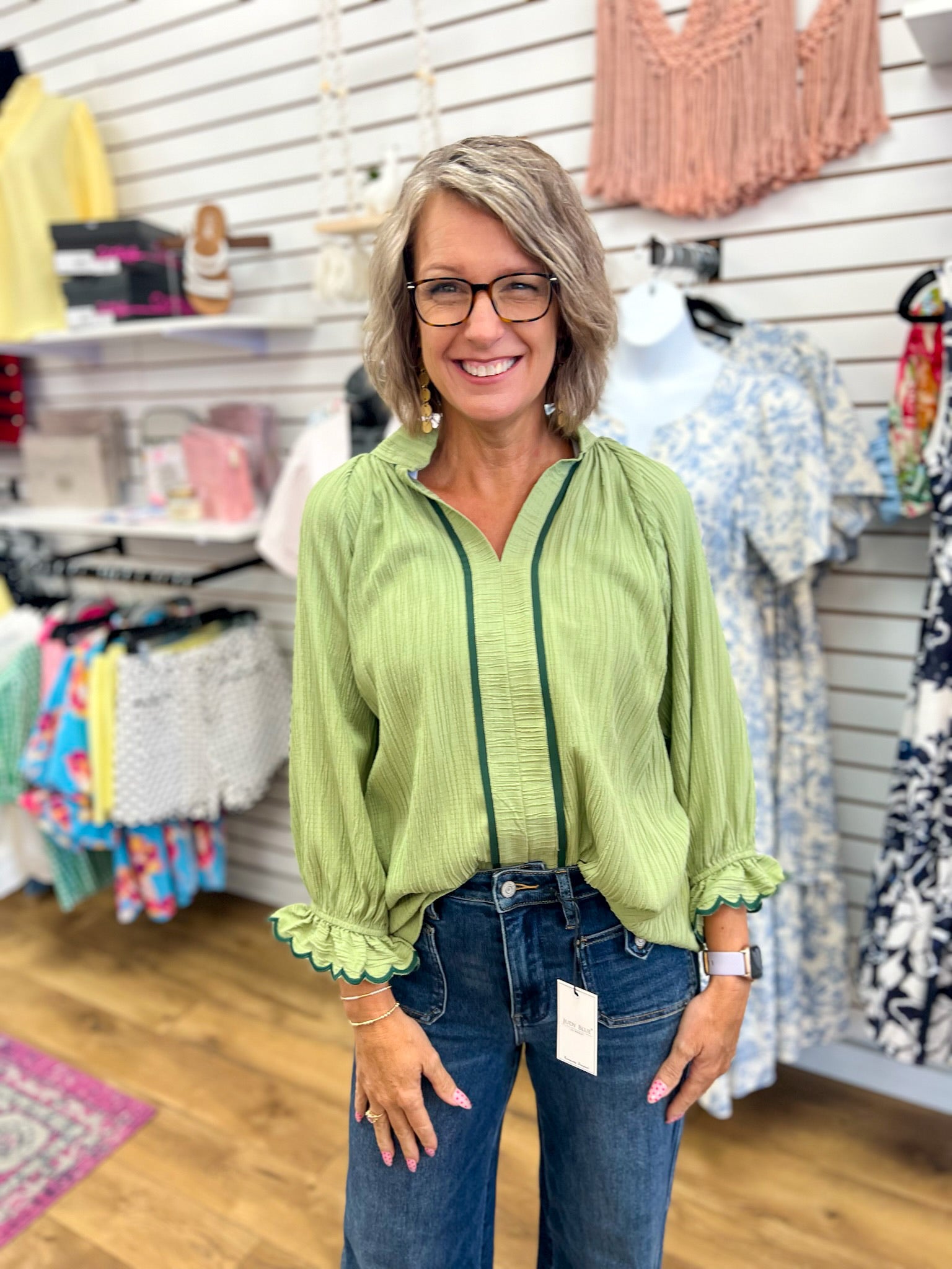 Sage green 3/4 sleeve blouse with contrast trim, scalloped cuffs, and split V-neckline