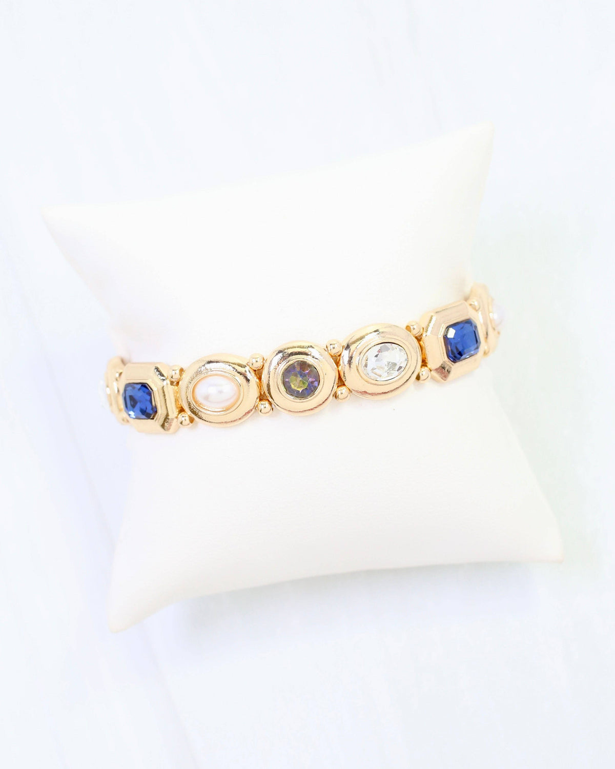 Gold stretch bracelet with blue sapphire, pearl, purple, and clear crystal stones