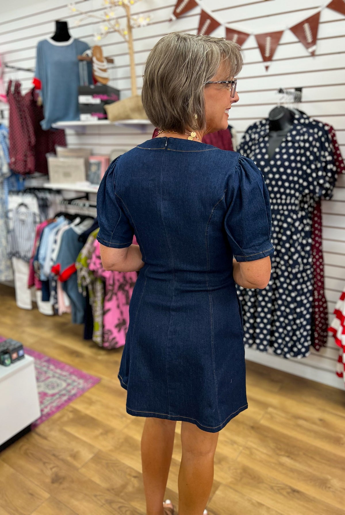 Dark denim short sleeve mini dress with puff shoulders and back seam detail
