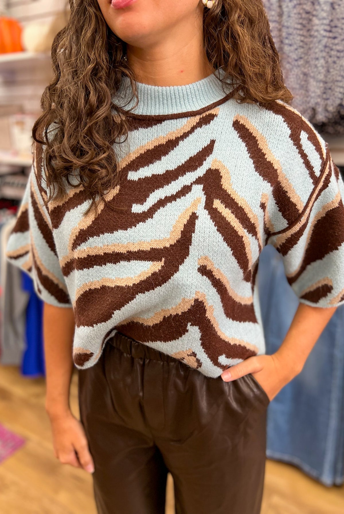 Light blue short sleeve knit sweater with brown animal print pattern and mock neck