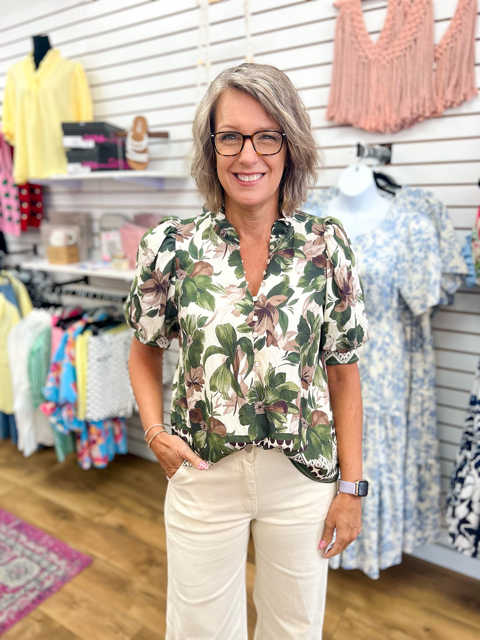 Entro olive floral short puff sleeve button-front top on model with cream pants
