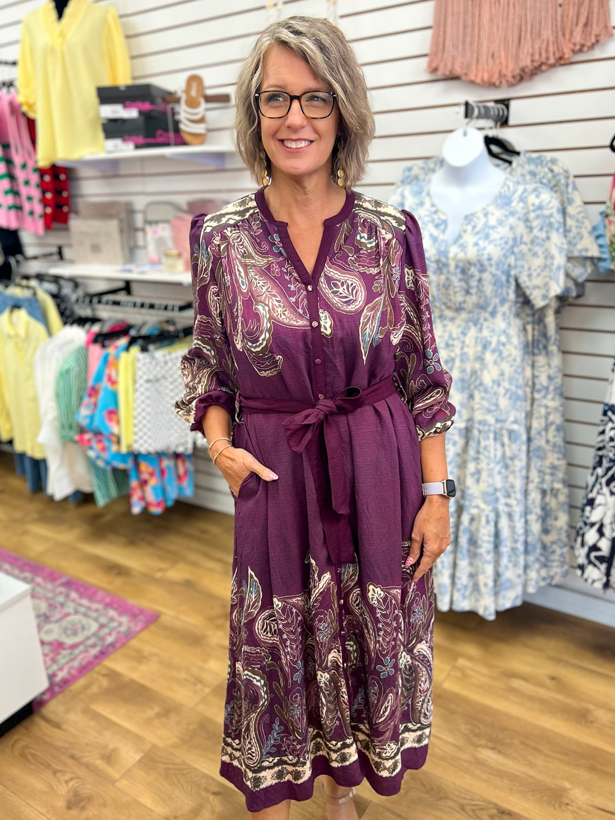 Plum paisley print midi dress with tie waist belt and 3/4 sleeves on model