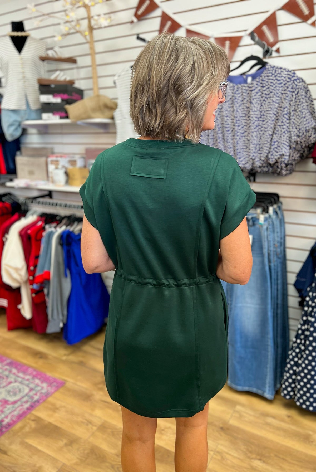 Hunter green short sleeve knit dress with drawstring waist, back view
