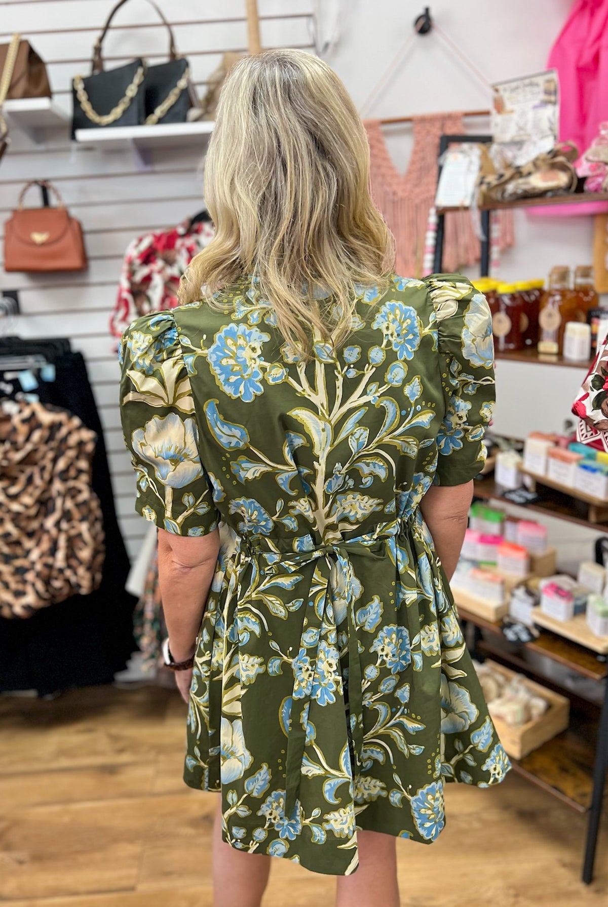 Entro olive green floral mini dress with puff sleeves and tie waist, back view