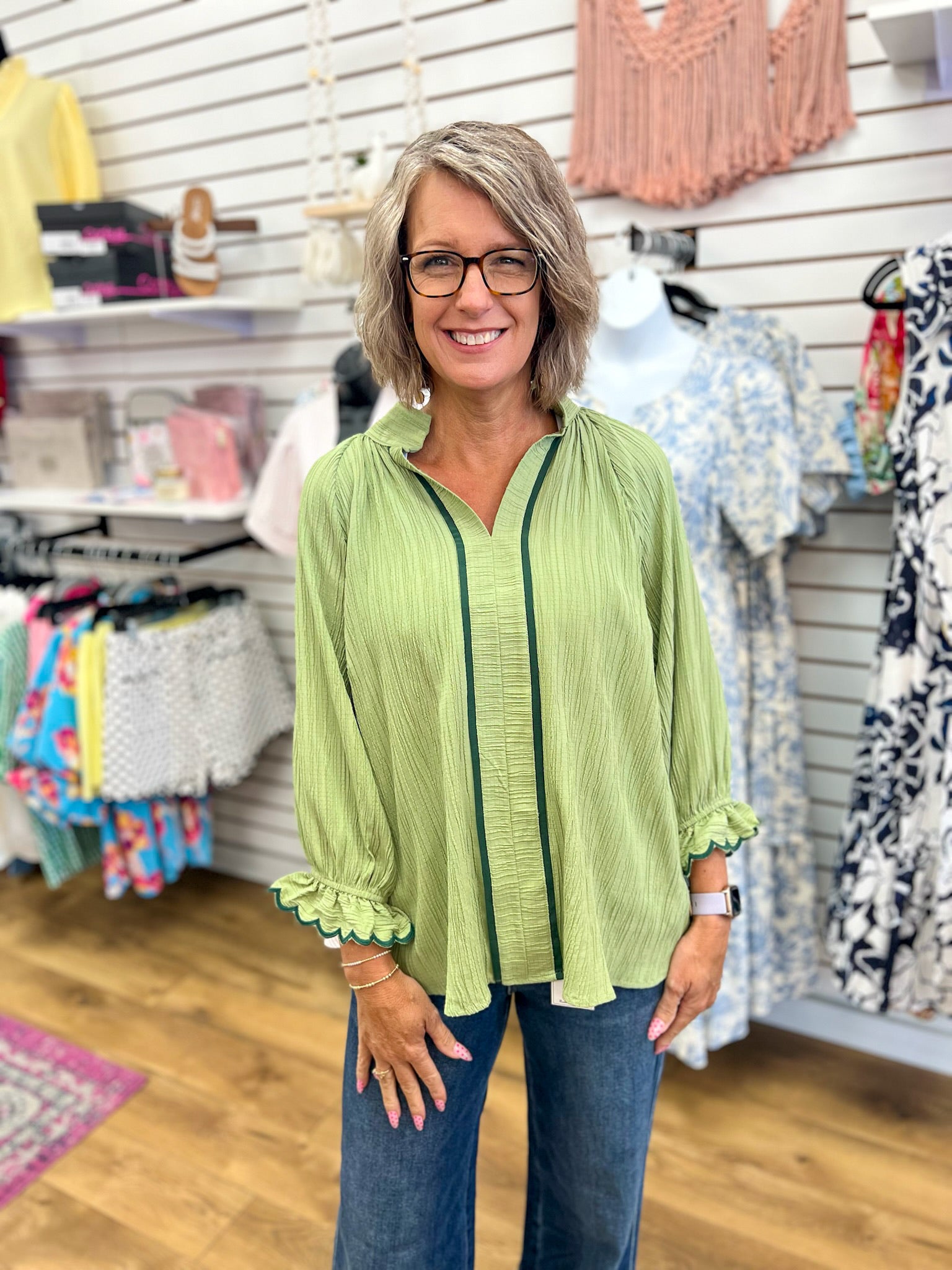 Sage green Umgee blouse with dark trim, ruffled 3/4 sleeves, and V-neckline