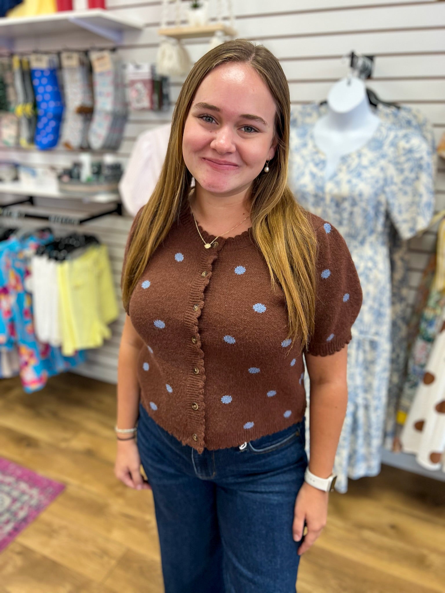 Brown knit short sleeve button-up sweater with blue polka dots and scalloped trim