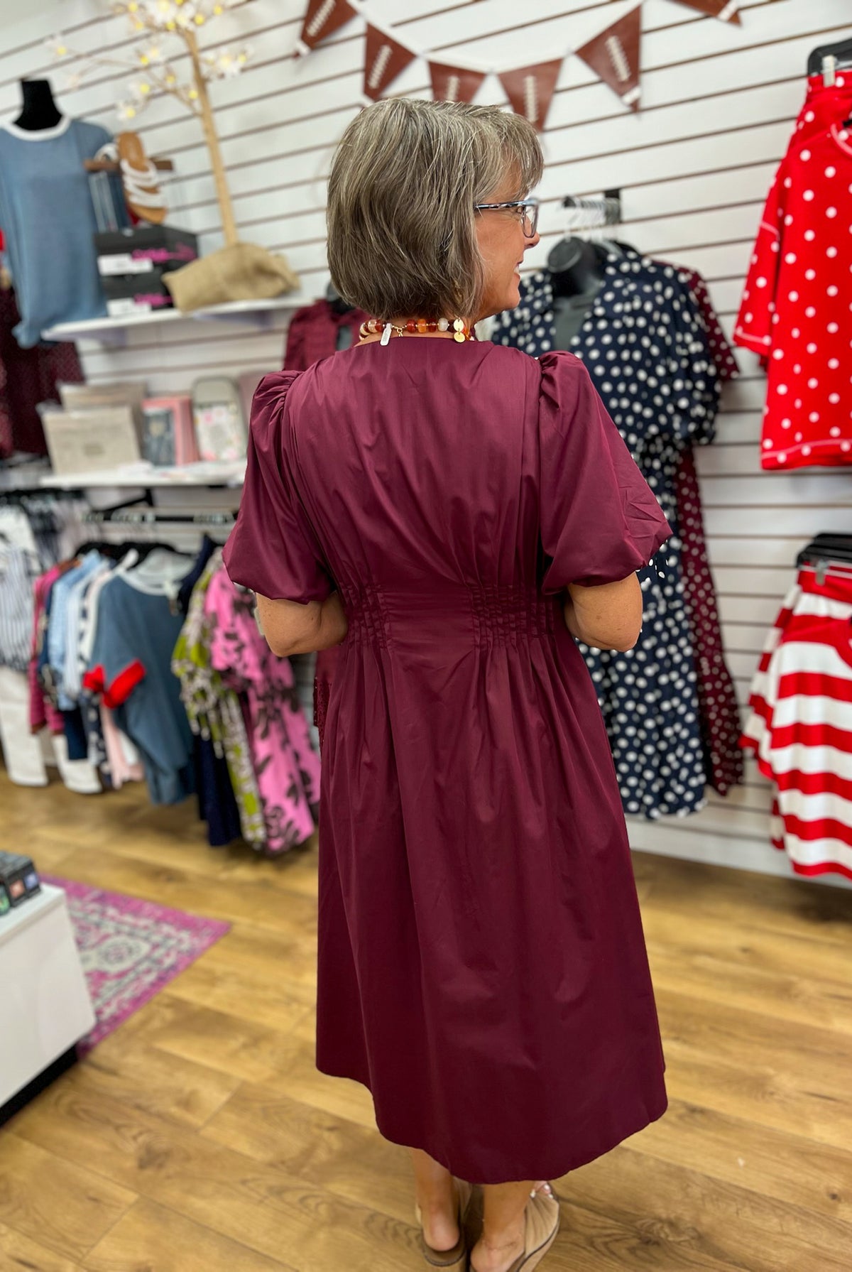 Wine burgundy midi dress with smocked waist and puff sleeves, back view