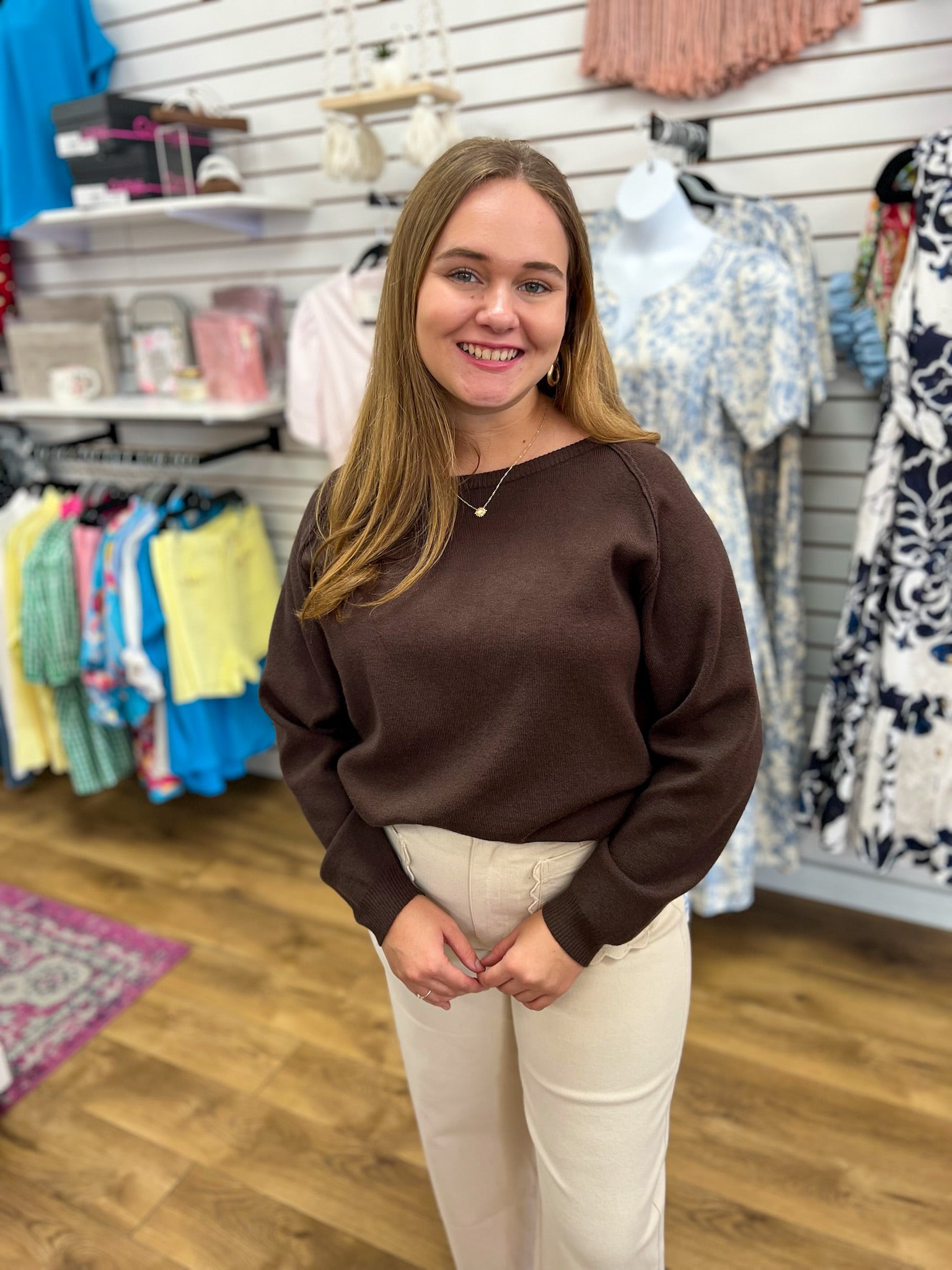 Chocolate brown boatneck knit sweater with long sleeves and ribbed hem