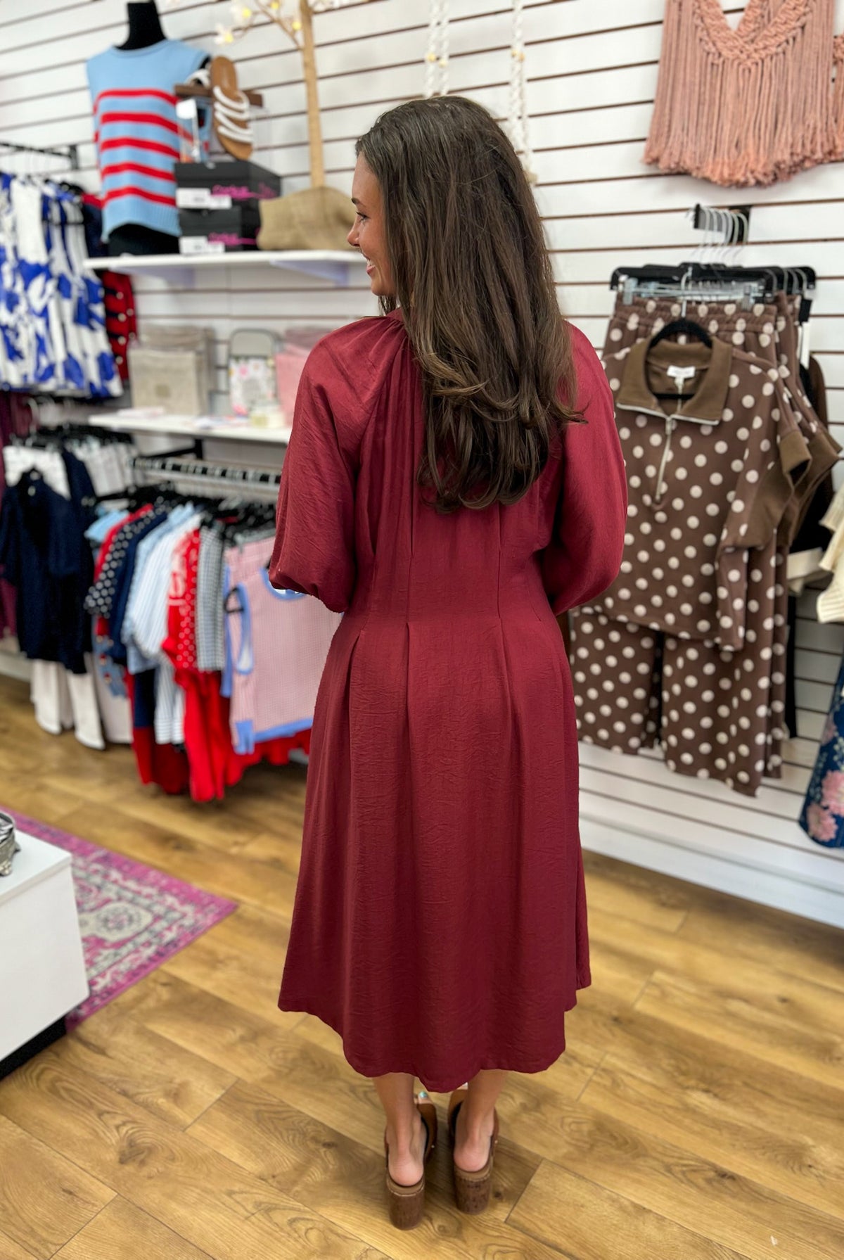 Burgundy long sleeve midi dress with flowy skirt, back view, by Entro