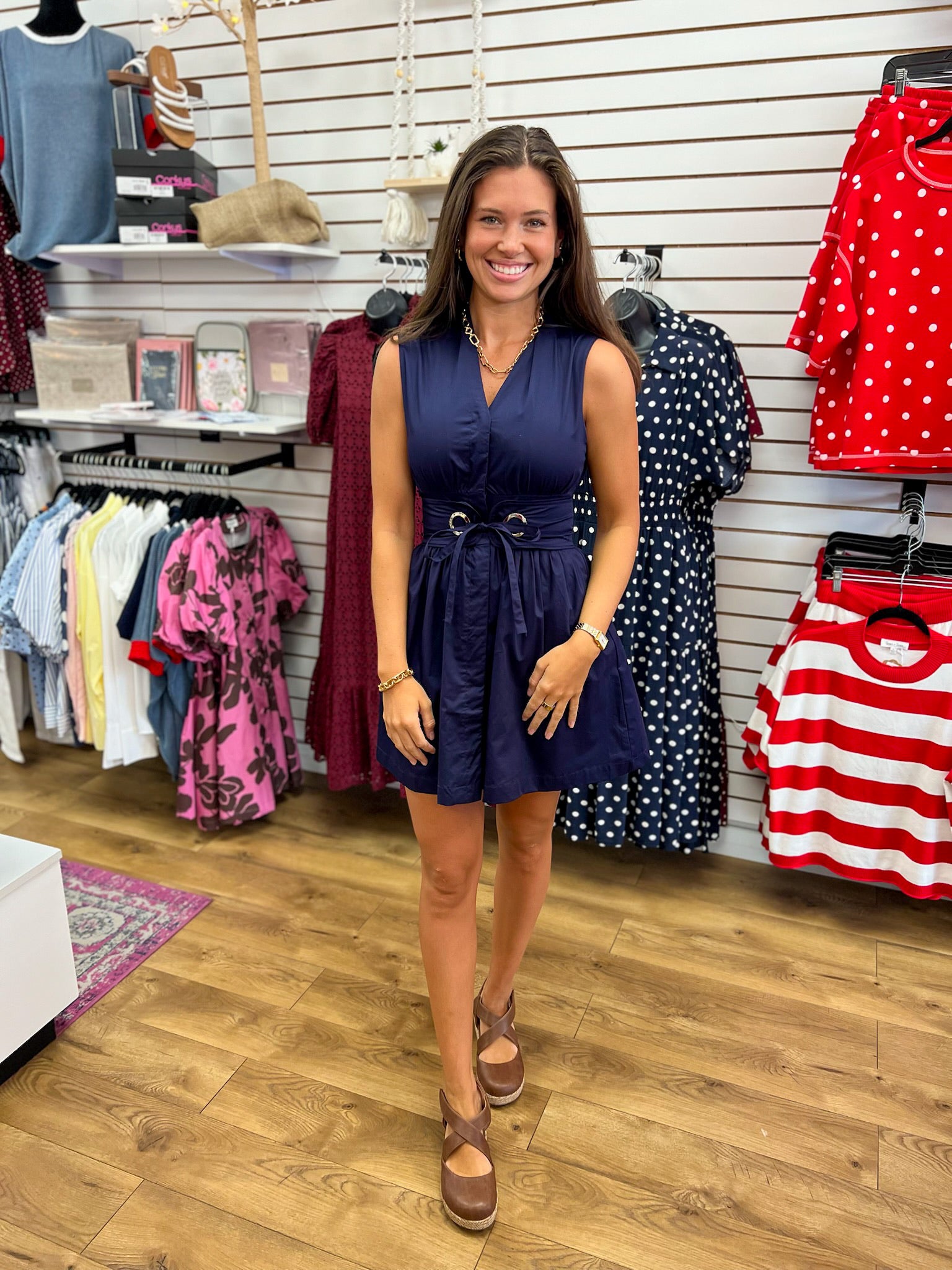 Navy blue sleeveless v-neck dress with removable tie belt and pleated skirt