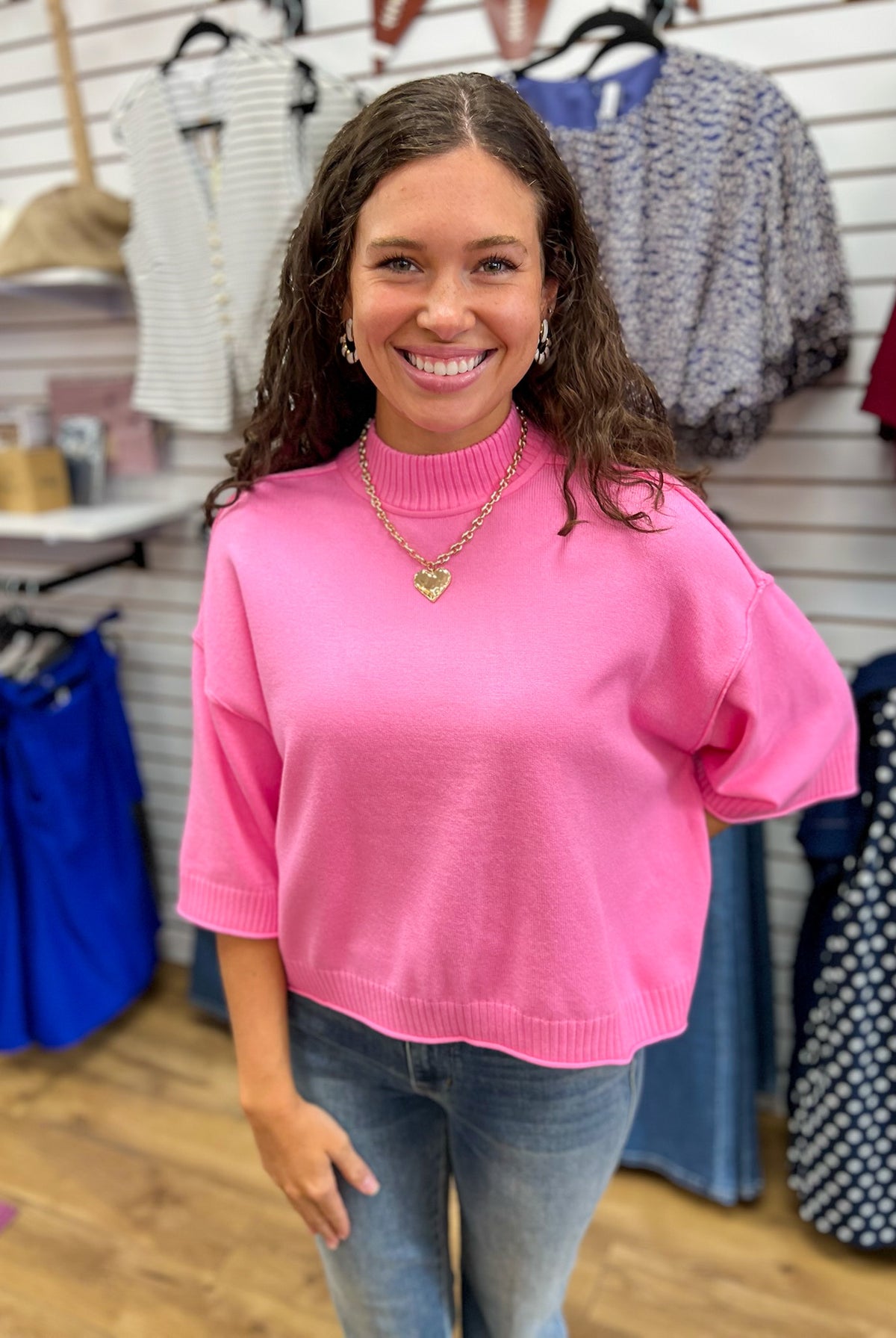 Glam pink mock neck cropped sweater with 3/4 sleeves, worn with jeans