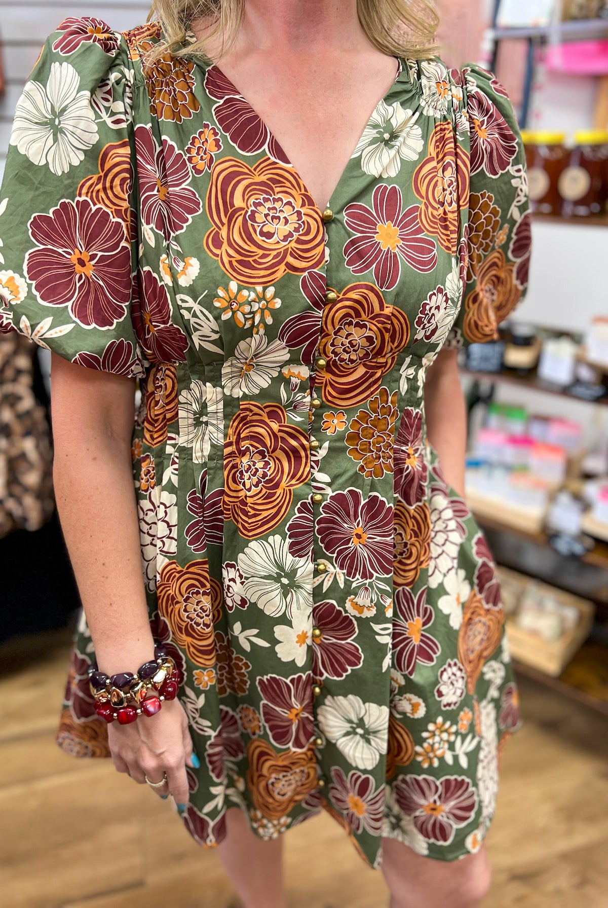 Olive green floral mini dress with rust and burgundy blooms and puff sleeves