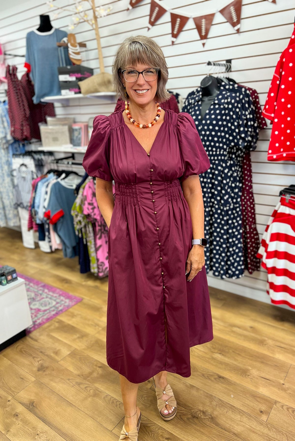 Wine burgundy midi dress with puff sleeves, gold buttons, smocked waist, and pockets