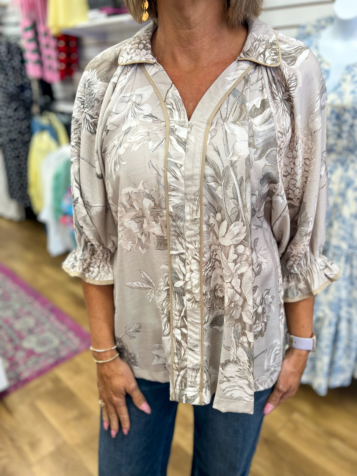 Taupe floral print blouse with 3/4 puff sleeves and contrast piping trim by Umgee