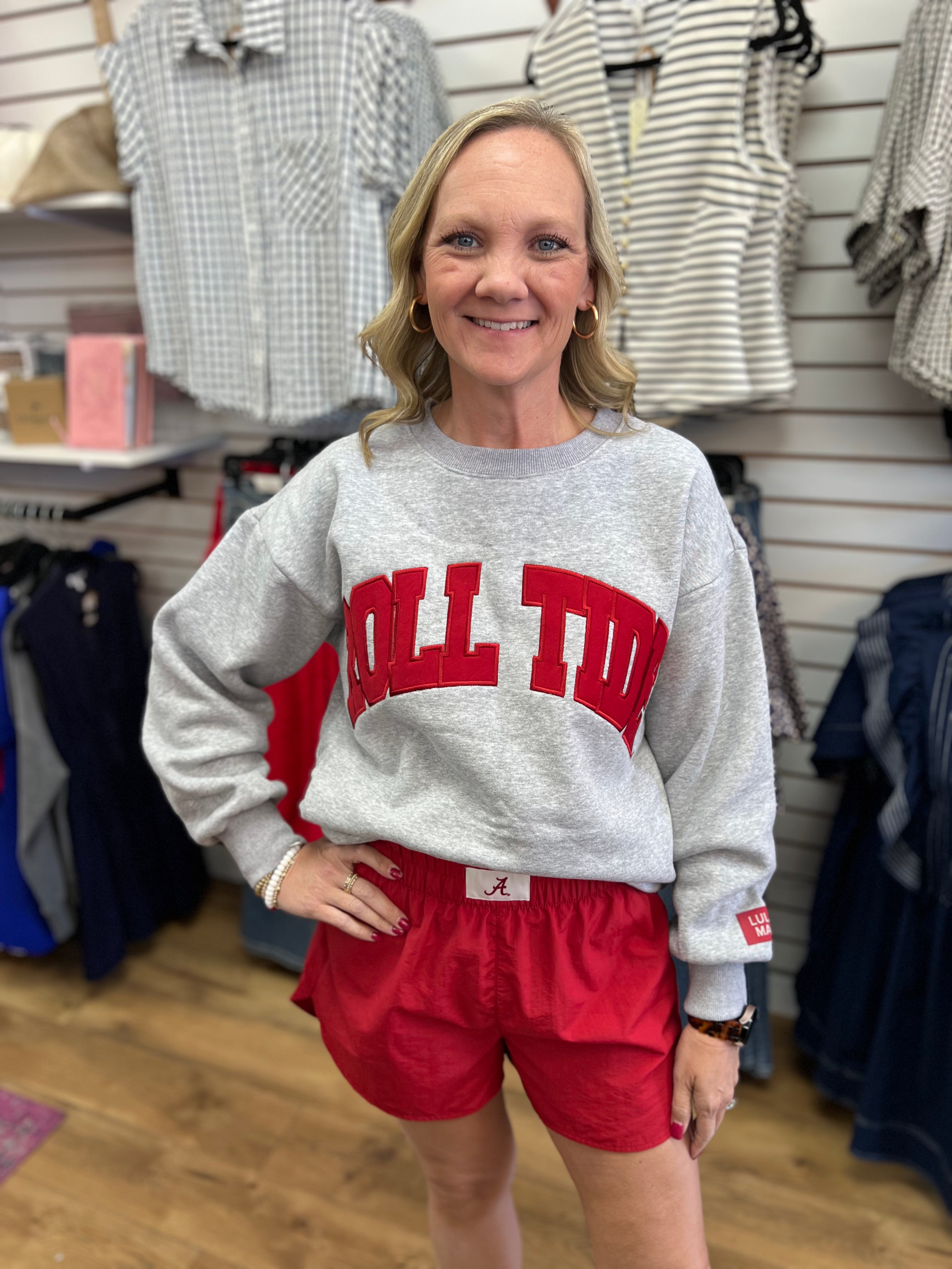 Grey Roll Tide crewneck sweatshirt with red embroidered letters, paired with red shorts