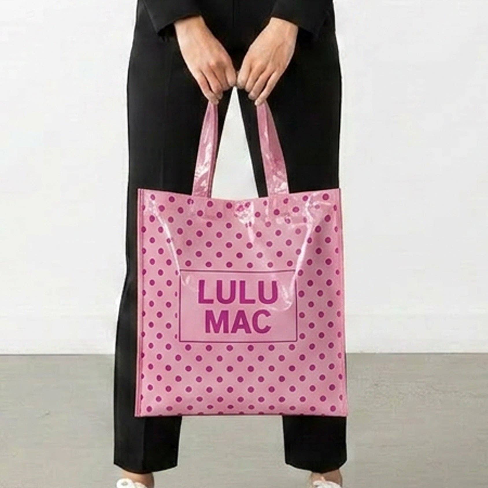 Light pink polka dot reusable tote bag with Lulu Mac branding and shoulder straps