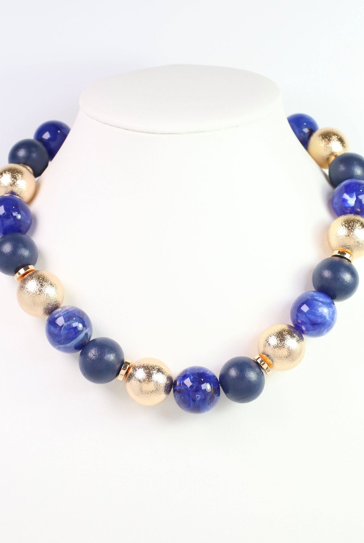 Caroline Hill Elaine navy blue and gold beaded ball statement necklace on display bust