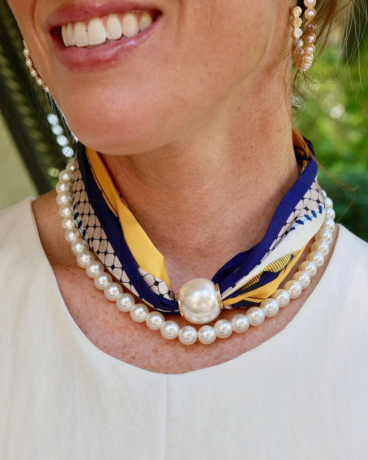 Two-strand pearl necklace with navy yellow scarf and oversized magnetic pearl clasp