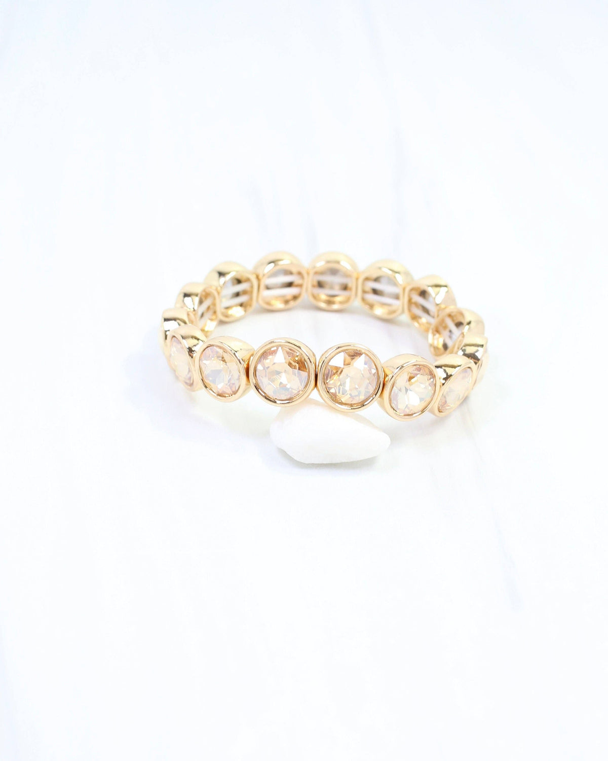 Gold stretch bracelet with round champagne crystal stones by Caroline Hill