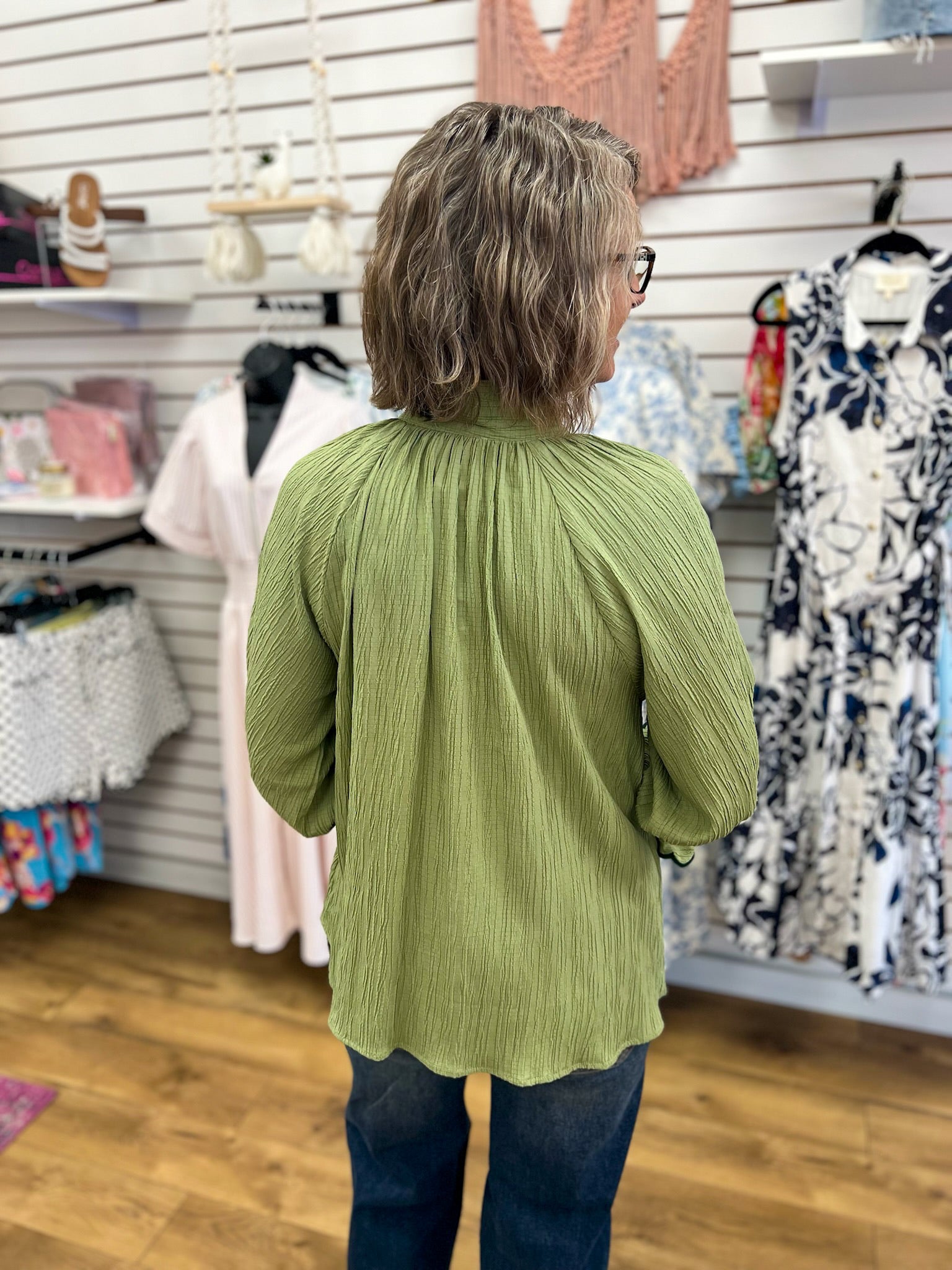 Sage green textured 3/4 sleeve blouse with gathered back detail, back view