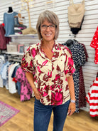 Entro wine and pink floral button-up top with short puff sleeves on model