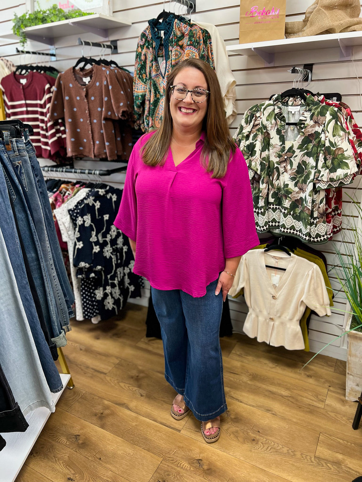 Magenta She + Sky V-neck top with 3/4 sleeves, worn with wide-leg jeans