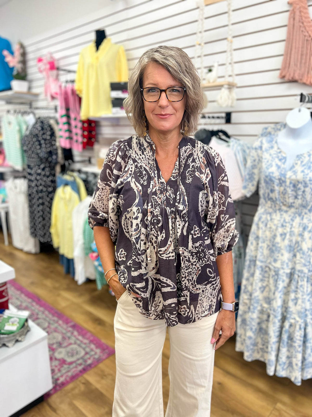 Black paisley boho top with 3/4 sleeves, split V-neckline, and flowy silhouette