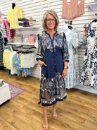 Navy blue paisley print button-front midi dress with 3/4 sleeves and border hem