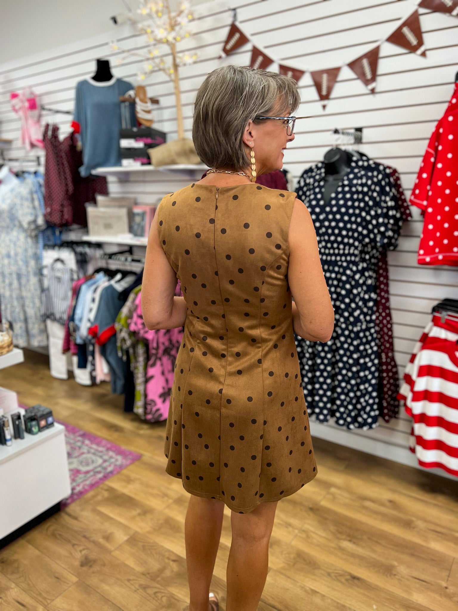 Brown sleeveless suede mini dress with dark polka dots and back zipper