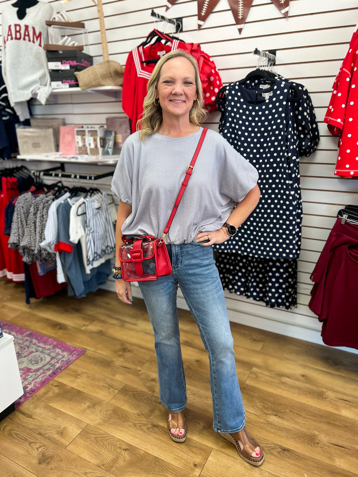 Grey mini checkered bubble hem top styled with jeans and red crossbody bag