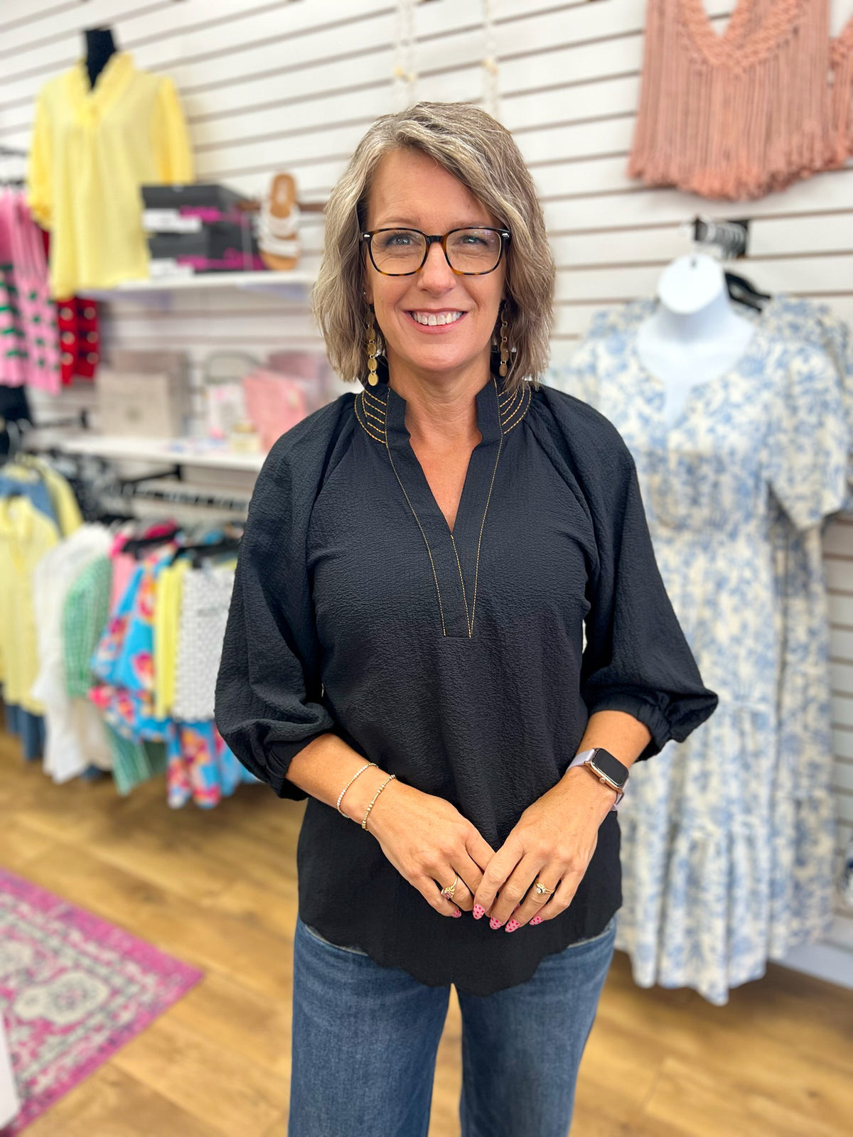 Umgee black v-neck top with 3/4 balloon sleeves and scalloped hem on model