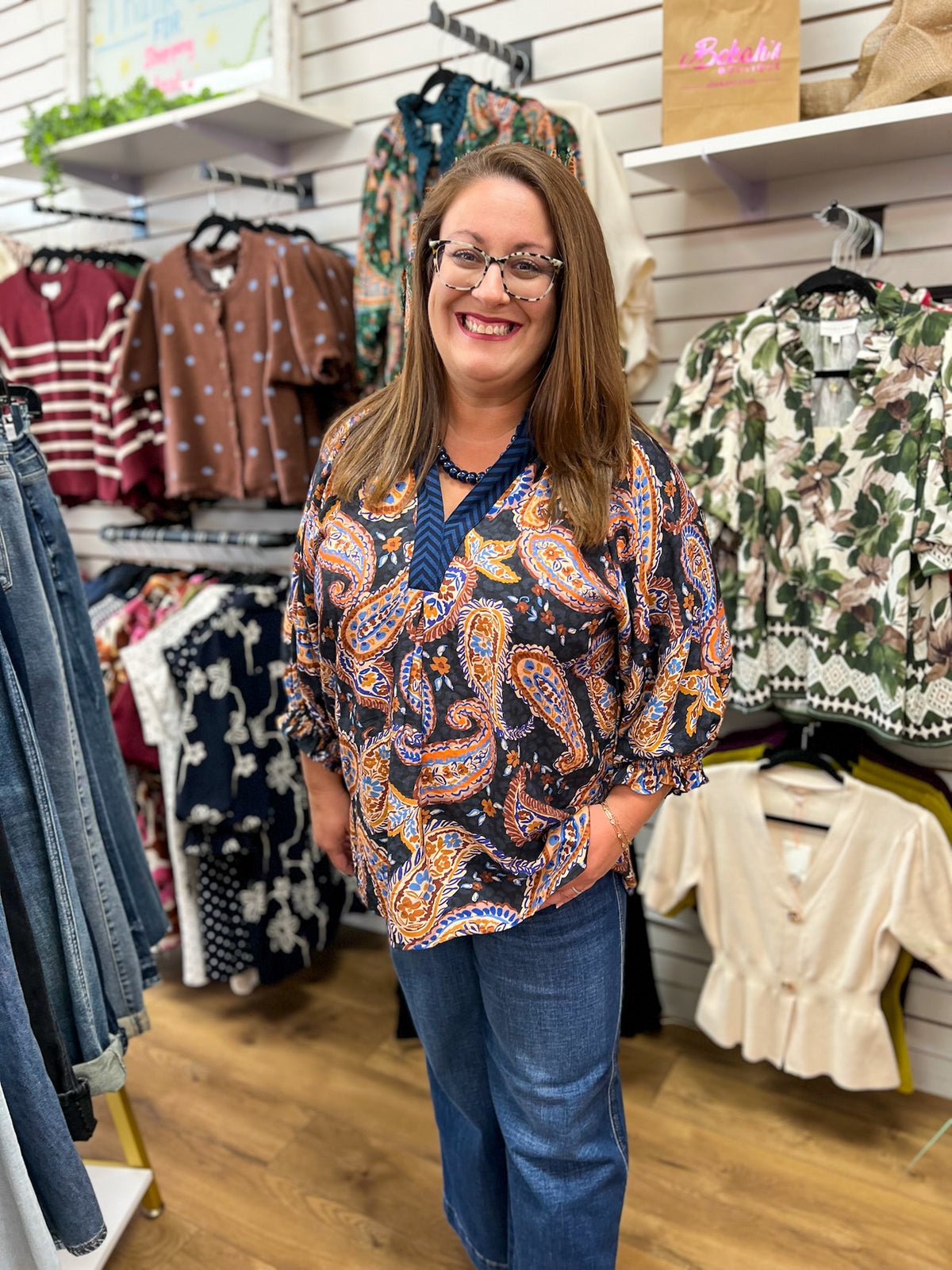 Black paisley print V-neck top with 3/4 balloon sleeves in orange and blue
