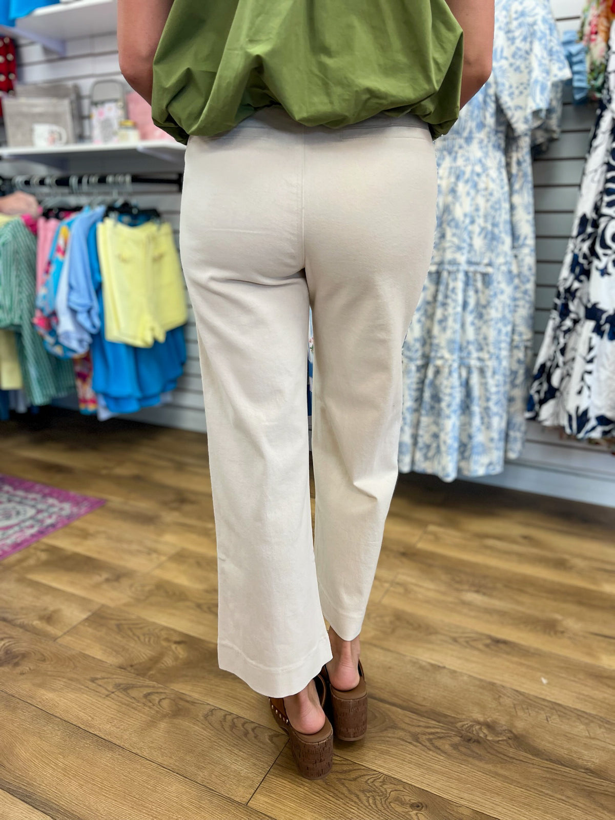 Entro ecru wide leg pants with scallop trim, back view, paired with green top