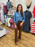 Blue chambray collared button-down top with 3/4 tab sleeves, worn with brown pants
