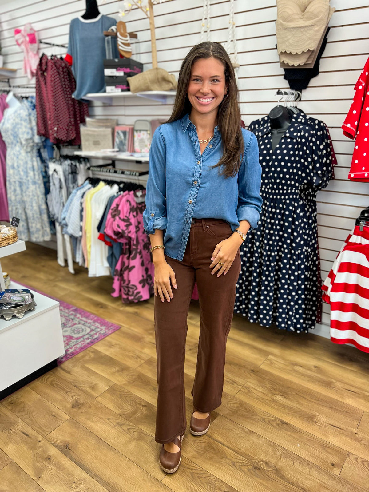 Blue chambray collared button-down top with 3/4 tab sleeves, worn with brown pants