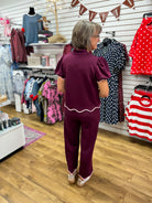 Plum puff sleeve v-neck pant set with pink scallop trim, back view