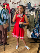 Red sleeveless square neck dress with white contrast stripe trim at hem