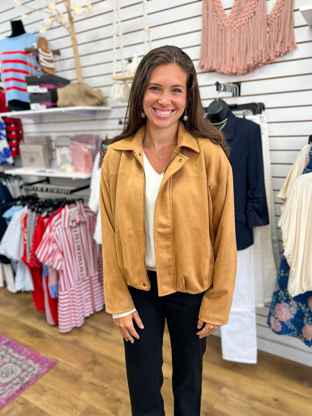 Camel faux suede zip-up bubble hem jacket worn over white top with black pants