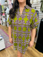 Olive green printed shirt dress with purple floral pattern and short puff sleeves